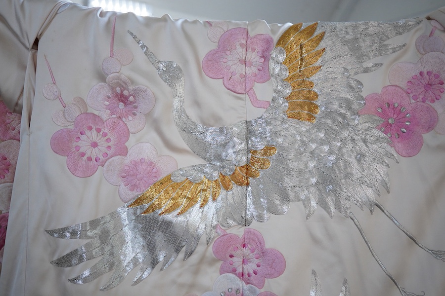 A Japanese pale pink silk floral and metallic thread bird embroidered wedding kimono, 184cm long.